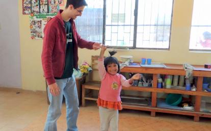 Early Childhood Development volunteer dancing with a child at his placement Projects Abroad Early Childhood Development volunteer dancing with a child during his spring break project placement